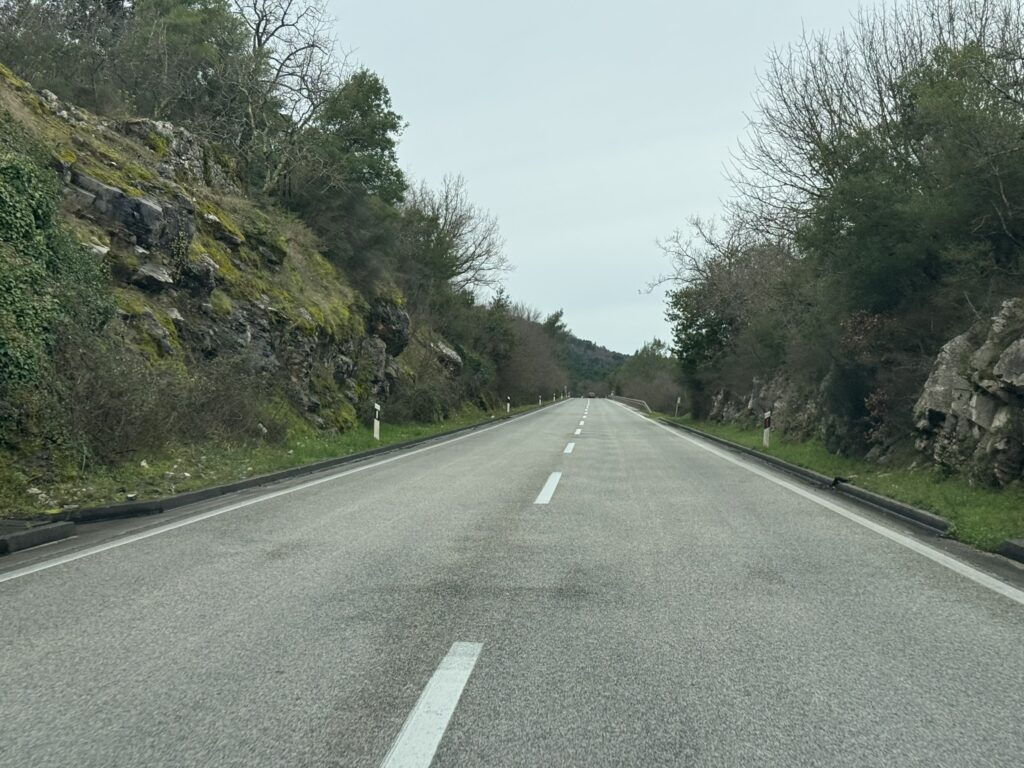 Croatian coastal road after Debeli Brijeg border — empty winter highway through rocky hills