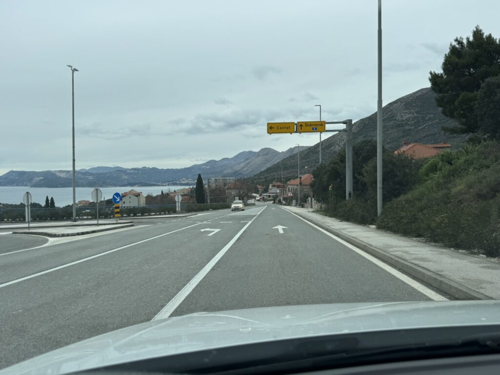 Road sign Cavtat and Dubrovnik on Croatian highway — approaching destination