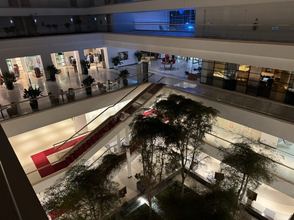 Rixos Premium Dubrovnik hotel atrium — multi-level interior with pool, shops and Valentine's decor