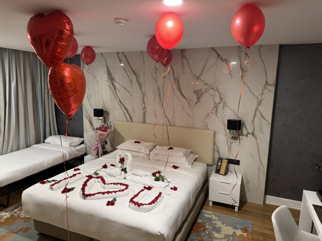Valentine's Day room at Rixos Premium Dubrovnik — balloons, roses, towel swans, heart on bed