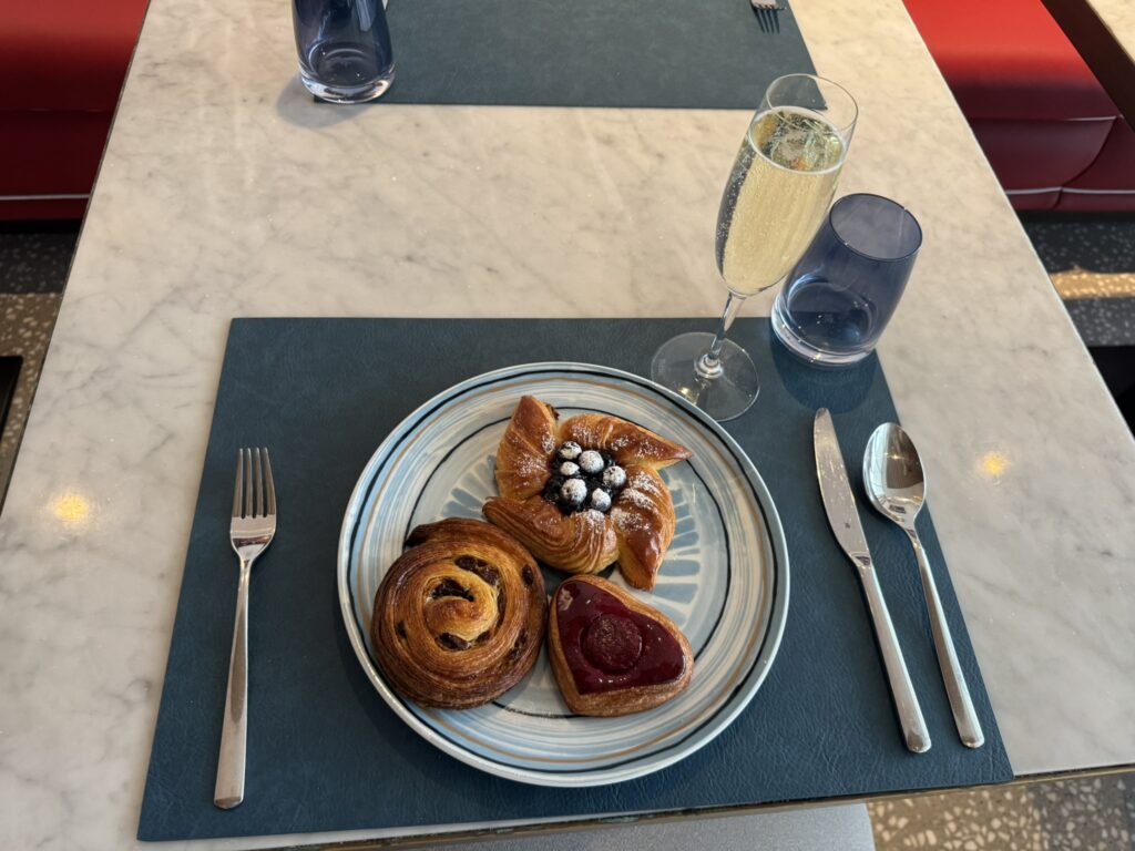 Breakfast at Rixos Premium Dubrovnik — fresh pastries with heart-shaped danish and champagne