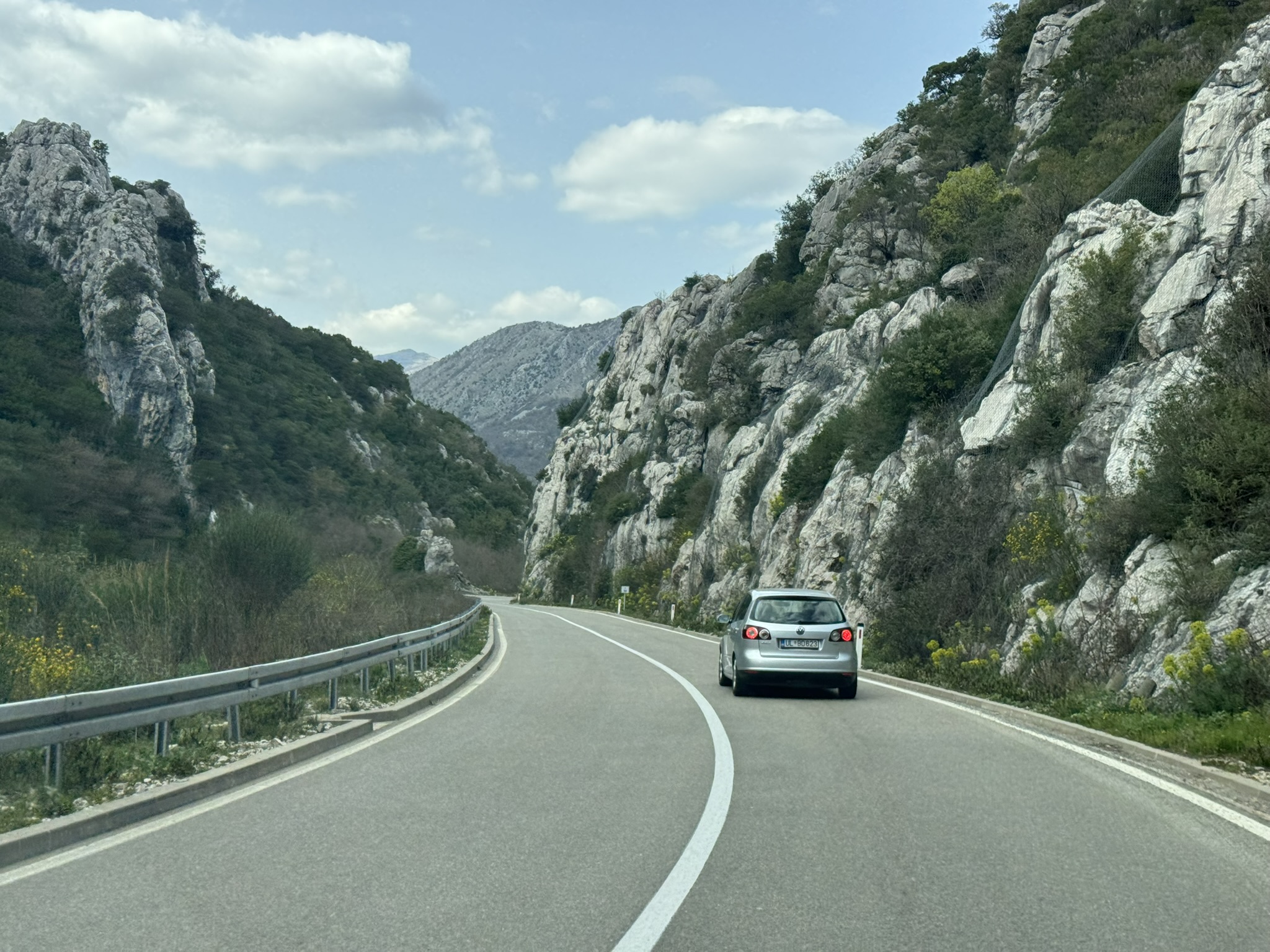 Scenic mountain road on the Budva to Albania drive during a family France road trip pre-journey