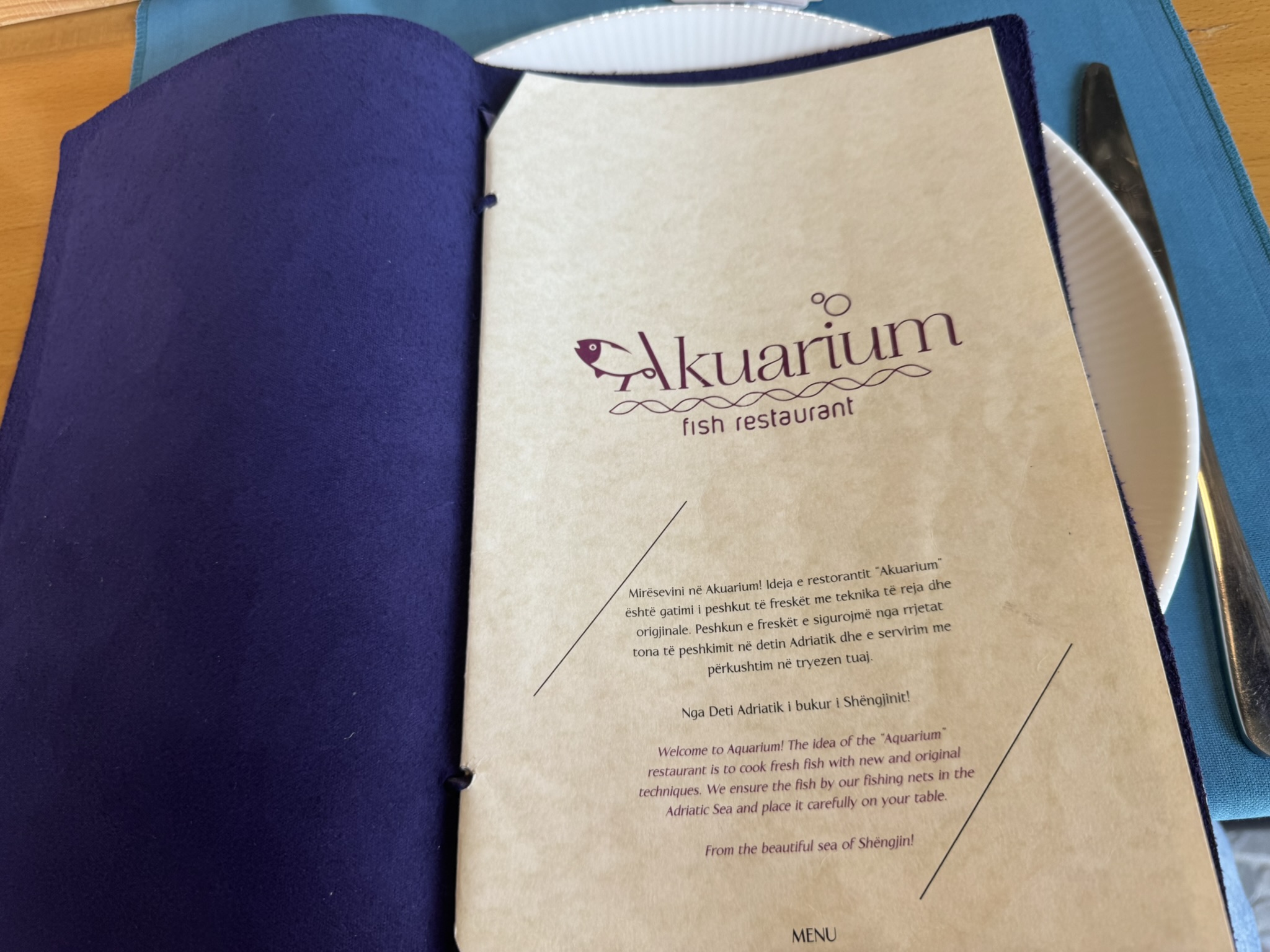Akuarium restaurant menu cover on the Budva to Shengjin route before the France road trip