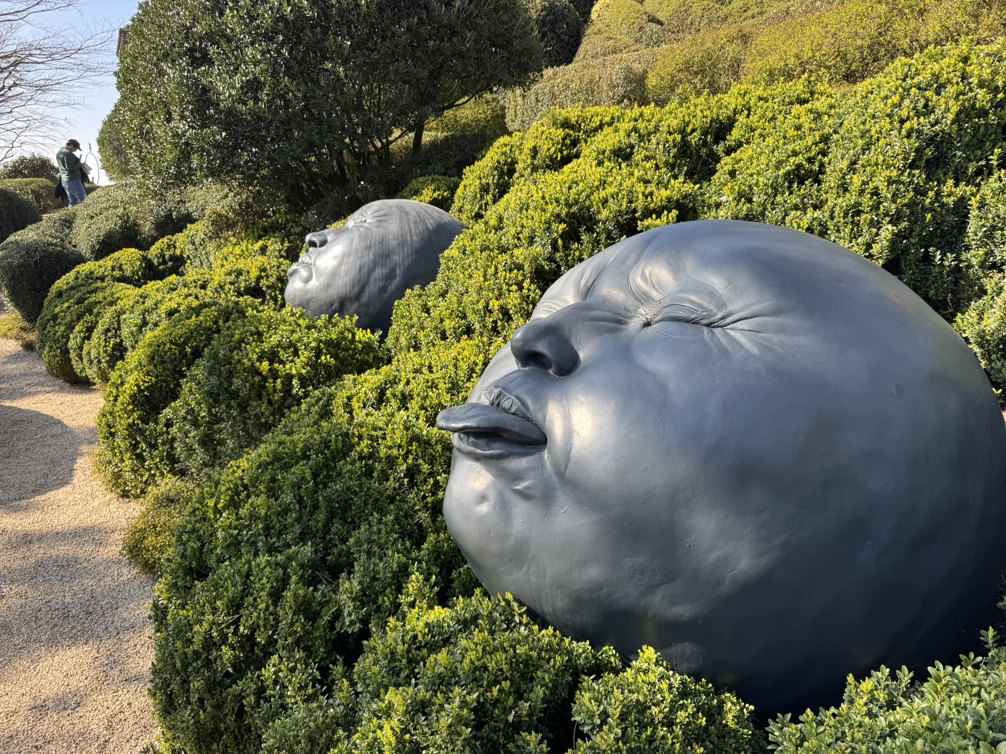 Face sculpture in Jardins d Etretat during a family France road trip in Normandy