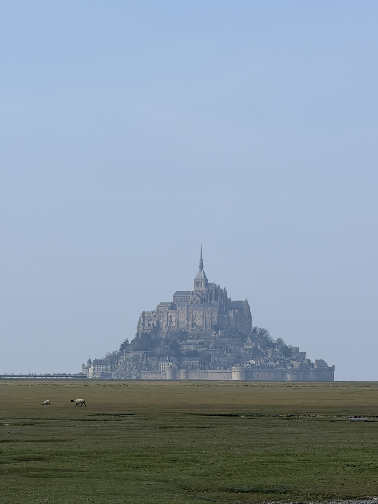 Long view of Mont Saint Michel from the countryside during a family France road trip