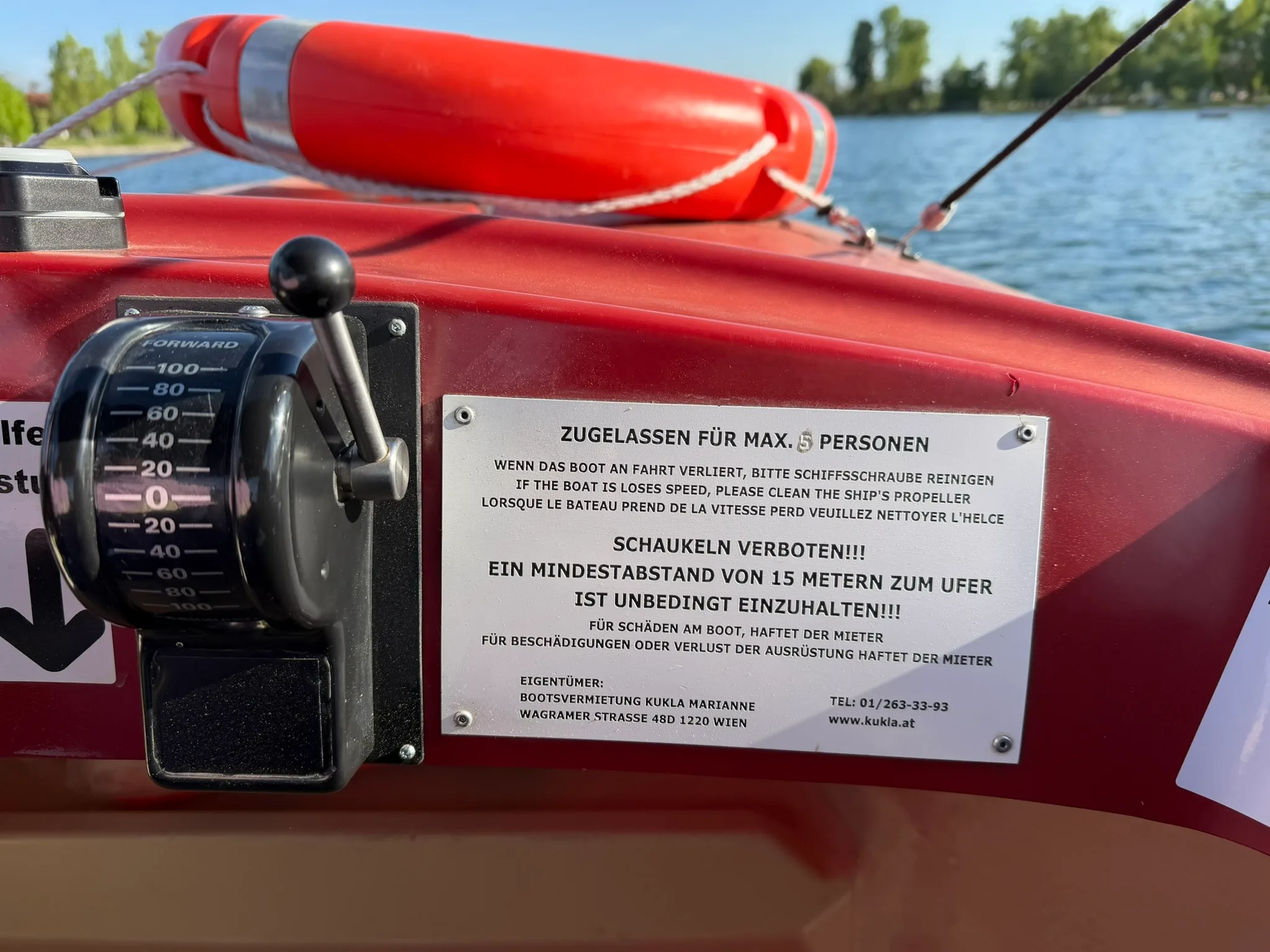 Boat control lever and rules sign inside an electric rental boat on Alte Donau.