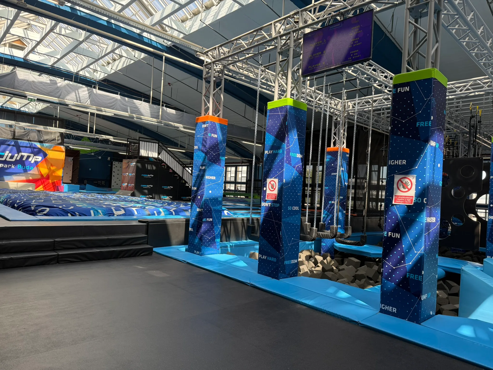 CyberJump Park Buda obstacle area with swings and foam pit.