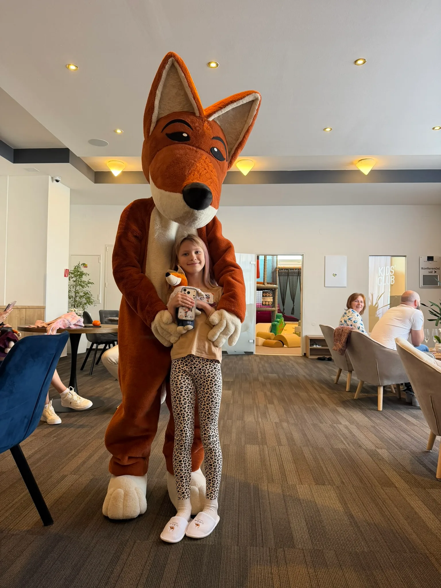 Child with a fox mascot at OREA Resort Santon kids club.