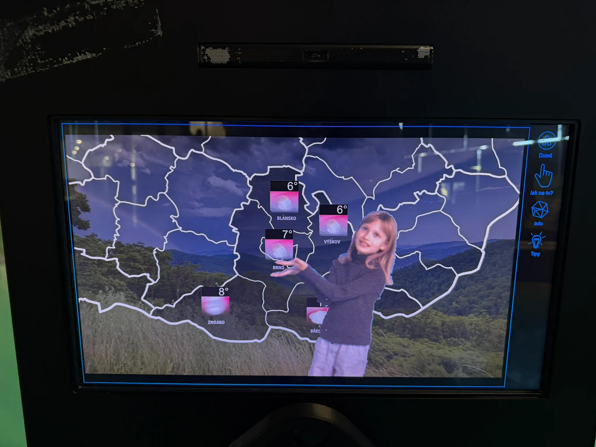 Child using the TV weather forecast studio at VIDA Science Centre in Brno.